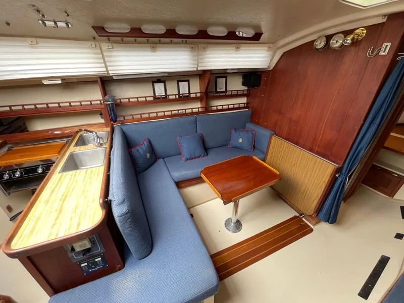 Slide: The Image of Interior of 1984 Catalina 30 sailboat with cozy seating and wooden table. - 7