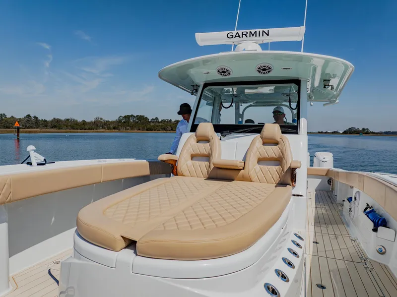 Slide: The Image of 2025 Freeman 38 boat with tan seating, Garmin equipment, on calm water. - 27