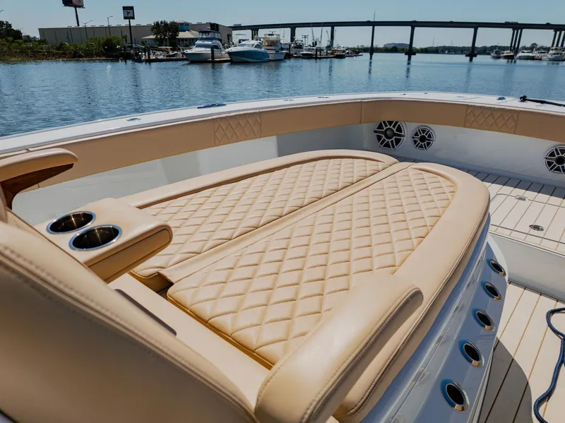 Slide: The Image of Luxurious seating on a 2025 Freeman 38 boat, docked by a marina. - 28