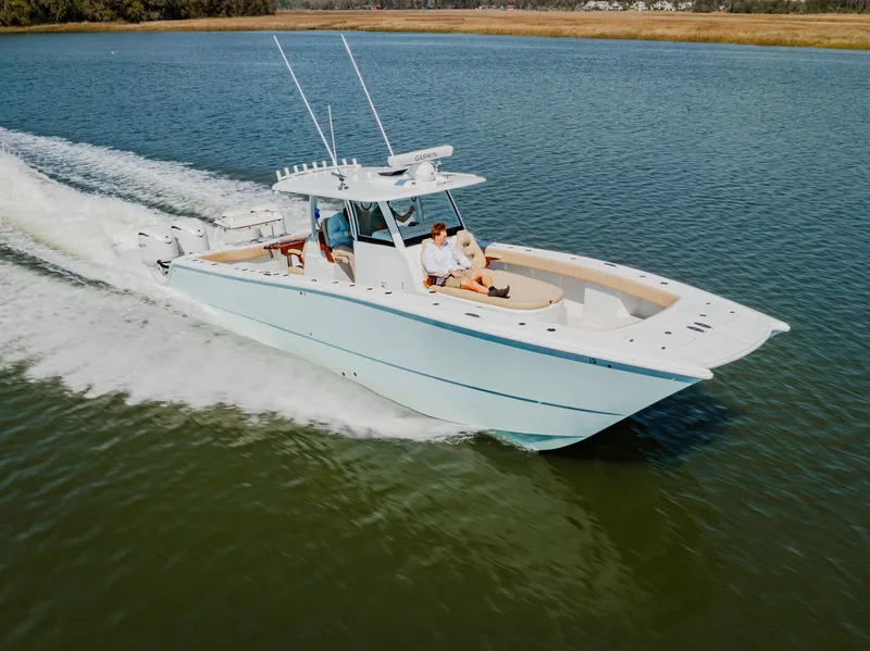 Slide: The Image of 2025 Freeman 38 boat cruising on calm water, featuring sleek design and spacious deck. - 3