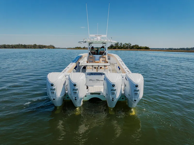 Slide: The Image of 2025 Freeman 38 boat with four powerful engines on a calm waterway. - 6