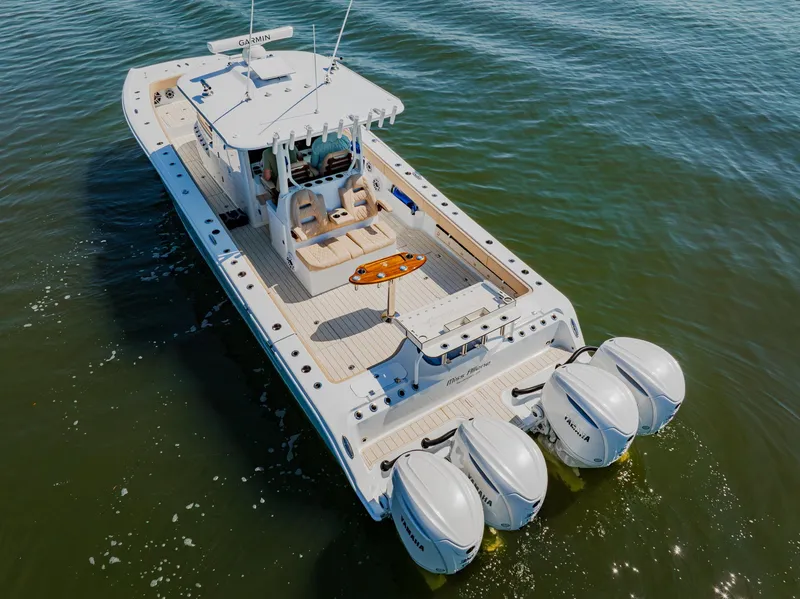 Slide: The Image of 2025 Freeman 38 boat with four engines cruising on open water. - 8