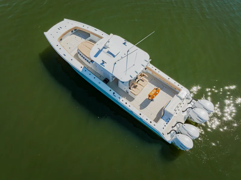 Slide: The Image of Aerial view of 2025 Freeman 38 boat with triple engines on calm water. - 9