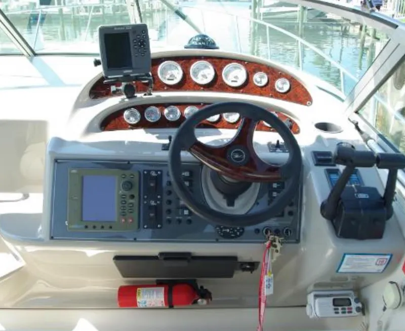 Slide: The Image of 2004 Monterey 322 Cruiser helm with steering wheel, gauges, and navigation equipment. - 11