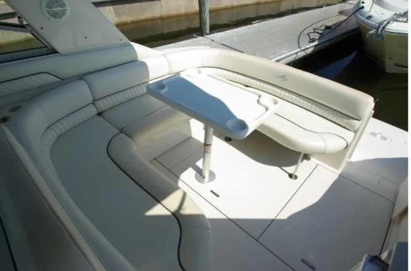 Slide: The Image of 2004 Monterey 322 Cruiser interior with white seating and table. - 6