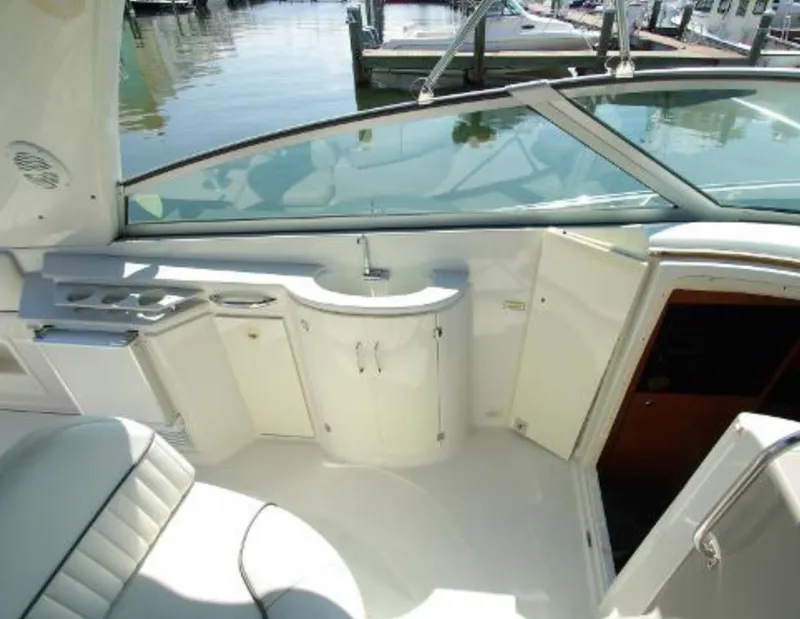 Slide: The Image of 2004 Monterey 322 Cruiser interior with sink and seating, docked at marina. - 9