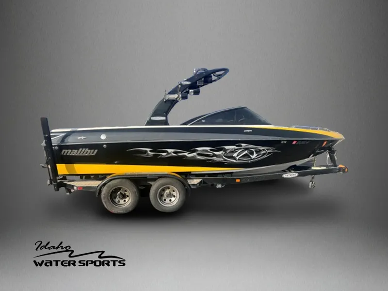 Slide: The Image of 2007 Malibu WVLX boat on trailer, black and yellow design, Idaho Water Sports logo. - 1