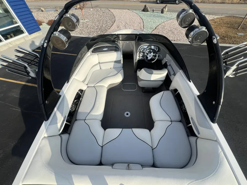 Slide: The Image of 2007 Malibu WVLX boat interior with white seating and black accents, featuring a modern dashboard. - 10