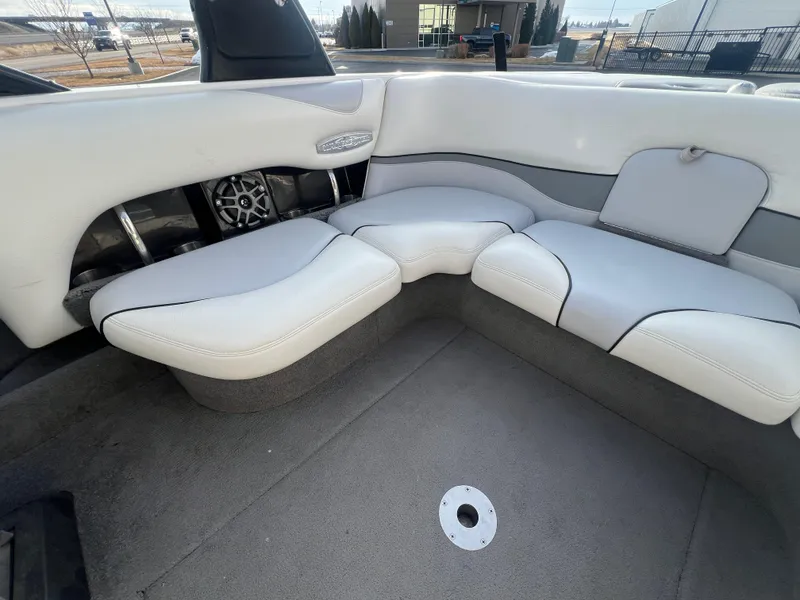 Slide: The Image of 2007 Malibu WVLX boat interior with white cushioned seating and speaker system. - 12
