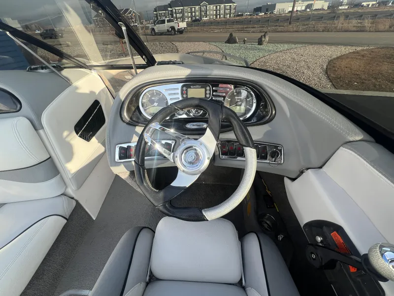 Slide: The Image of 2007 Malibu WVLX boat interior with steering wheel and dashboard controls. - 14