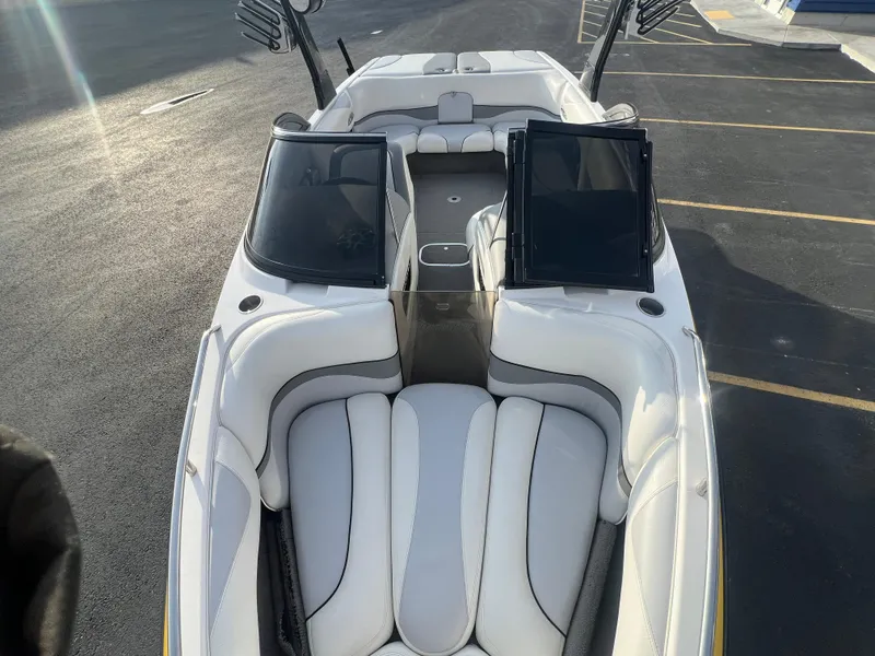Slide: The Image of 2007 Malibu WVLX boat interior with white seating and open windshield. - 16