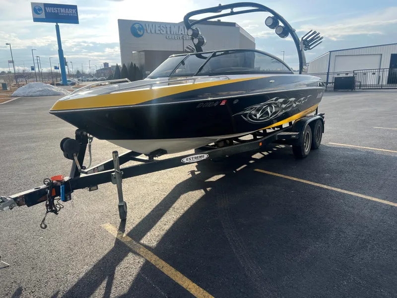 Slide: The Image of 2007 Malibu WVLX boat on trailer in parking lot, near Westmark Credit Union. - 5