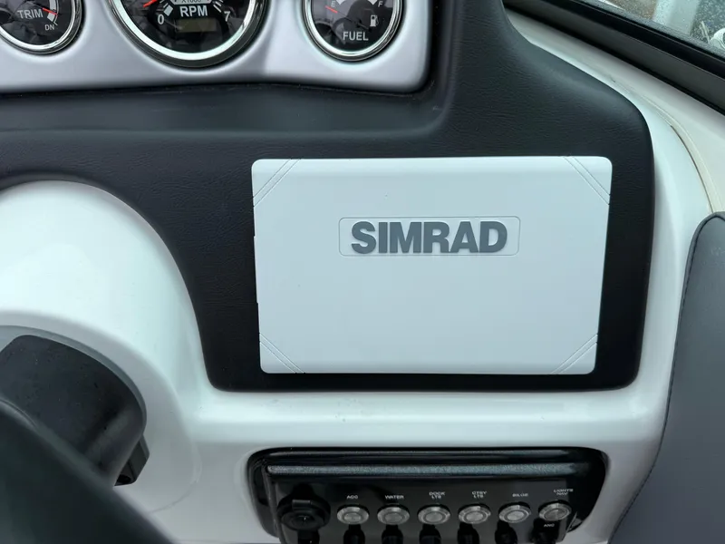 Slide: The Image of Dashboard of 2024 NauticStar 243 DC Deck boat with Simrad display and gauges. - 25