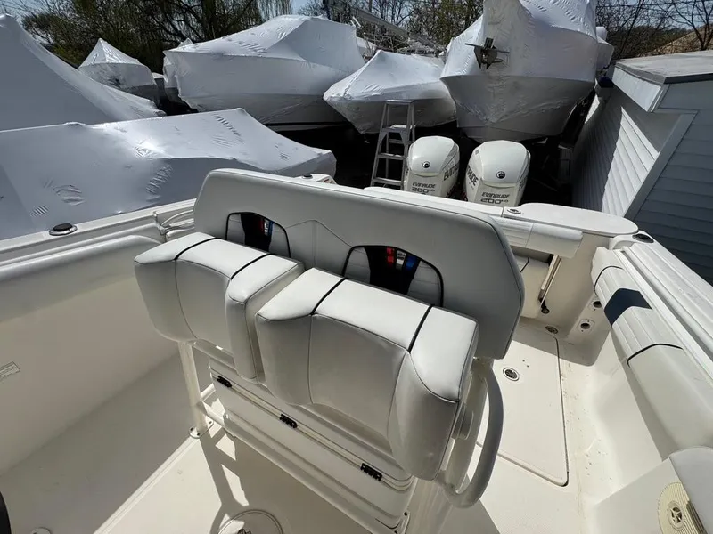 Slide: The Image of 2016 Wellcraft 252 Fisherman boat interior with dual seats and covered engines. - 11