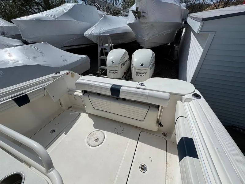 Slide: The Image of 2016 Wellcraft 252 Fisherman boat with twin Evinrude engines, stored outdoors. - 14