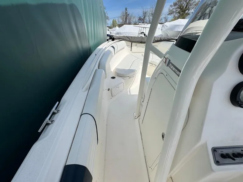 Slide: The Image of 2016 Wellcraft 252 Fisherman boat interior, featuring sleek white design and spacious deck layout. - 17