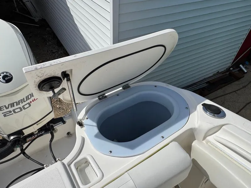 Slide: The Image of 2016 Wellcraft 252 Fisherman boat with open storage compartment and Evinrude 200 HP engine. - 19