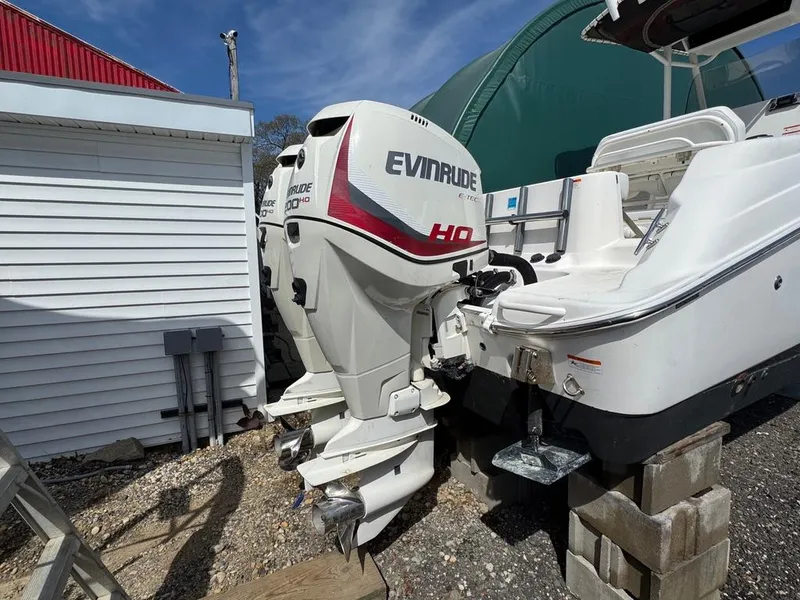 Slide: The Image of 2016 Wellcraft 252 Fisherman with Evinrude outboard motor on blocks, outdoor storage. - 25