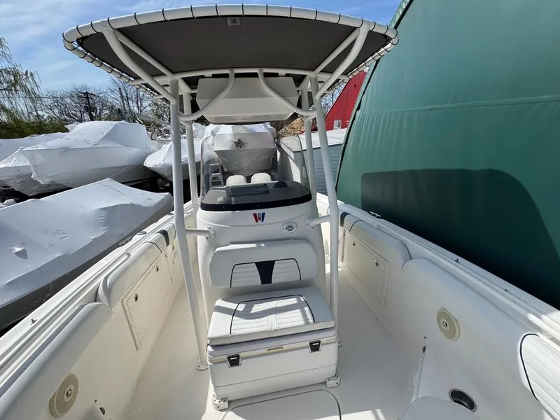 Slide: The Image of 2016 Wellcraft 252 Fisherman boat with T-top and seating, docked outdoors. - 6