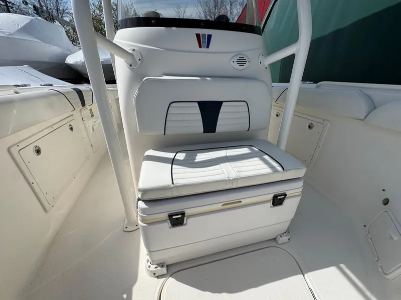 Slide: The Image of 2016 Wellcraft 252 Fisherman boat interior with white seating and storage compartment. - 7