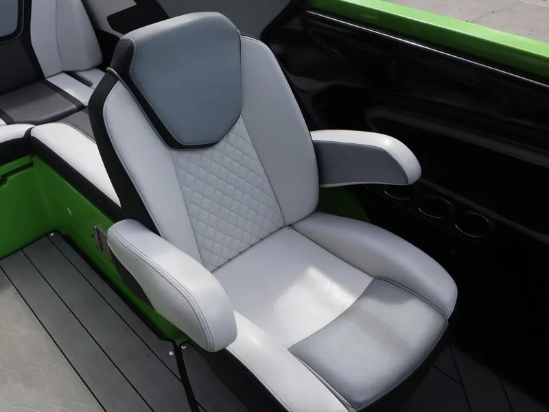 Slide: The Image of 2022 Yamaha Boats 255XD seat with gray and white upholstery, featuring a modern design. - 11