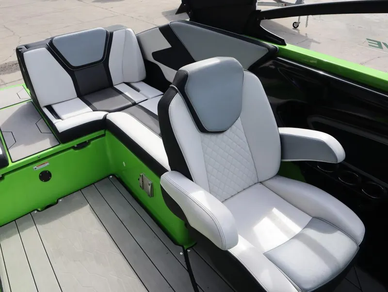 Slide: The Image of 2022 Yamaha Boats 255XD interior with white and black seating, green accents. - 12