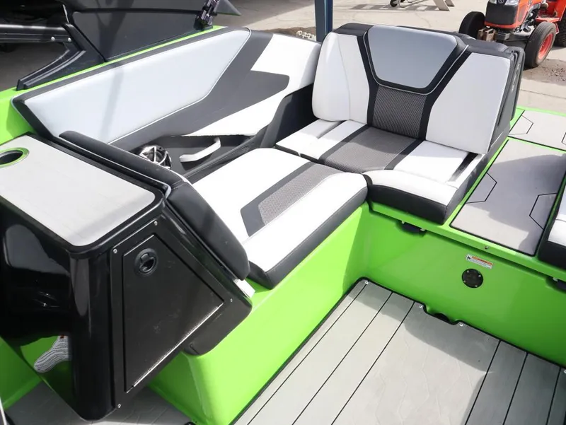Slide: The Image of 2022 Yamaha Boats 255XD interior with modern seating and vibrant green accents. - 13