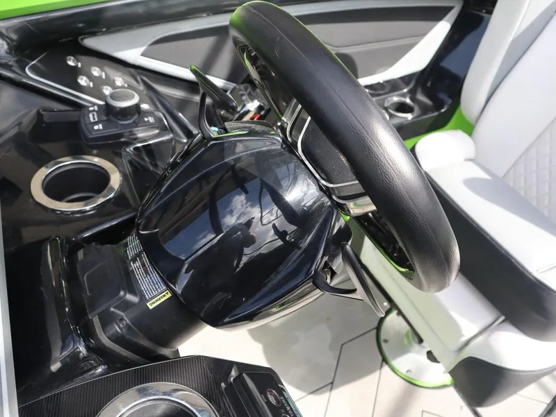 Slide: The Image of Interior view of 2022 Yamaha Boats 255XD steering wheel and controls. - 19