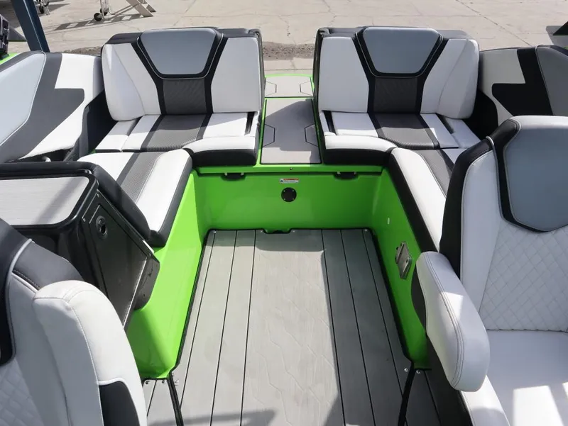 Slide: The Image of Interior of 2022 Yamaha Boats 255XD with stylish seating and vibrant green accents. - 21