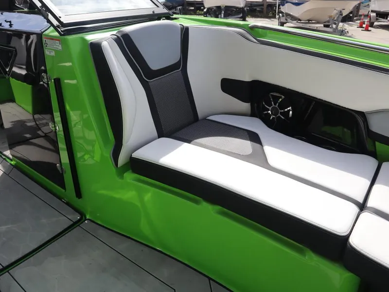 Slide: The Image of 2022 Yamaha Boats 255XD interior with green and white seating. - 23