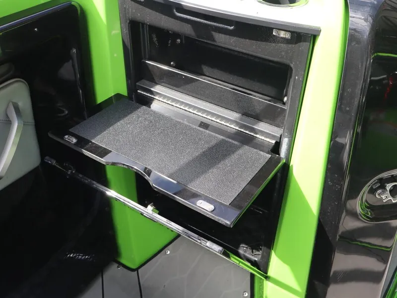 Slide: The Image of 2022 Yamaha Boats 255XD interior with a fold-out storage compartment. - 25