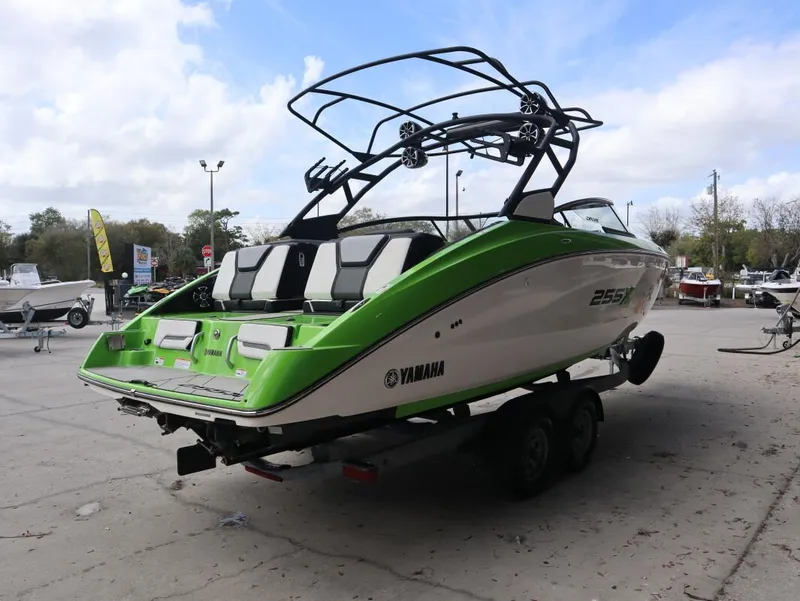 Slide: The Image of 2022 Yamaha Boats 255XD in green and white on trailer, outdoor display. - 3