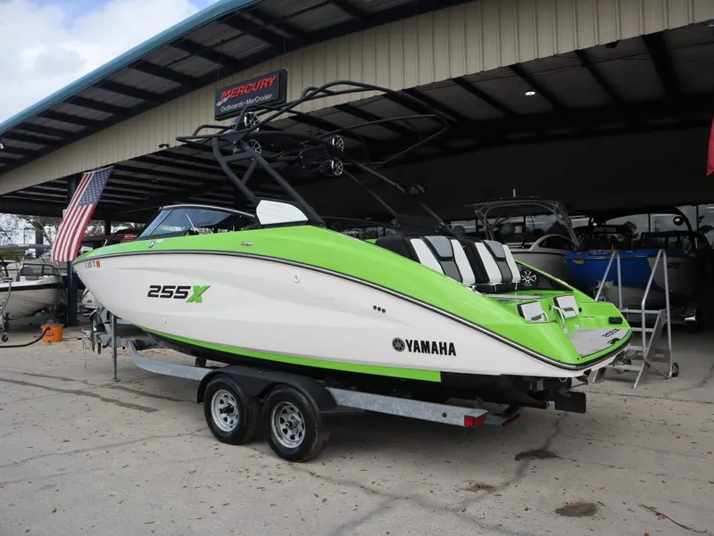 Slide: The Image of 2022 Yamaha Boats 255XD in vibrant green on trailer at dealership. - 5
