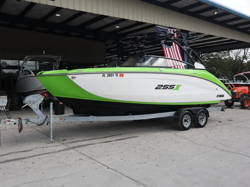 Slide: The Image of 2022 Yamaha Boats 255XD in green and white on a trailer. - 6