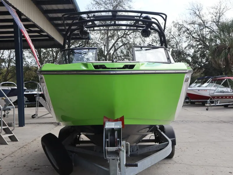 Slide: The Image of 2022 Yamaha Boats 255XD in vibrant green on a trailer, front view. - 7