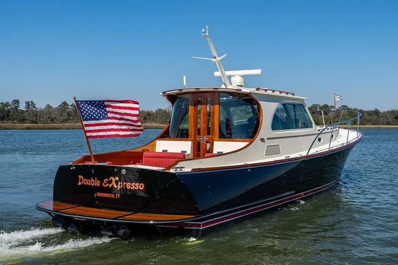 The Image of 2006 Hinckley Talaria 44 MY yacht cruising with American flag on water. - 0