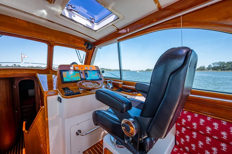 Slide: The Image of Interior of 2006 Hinckley Talaria 44 MY yacht with helm, leather chair, and scenic window view. - 12