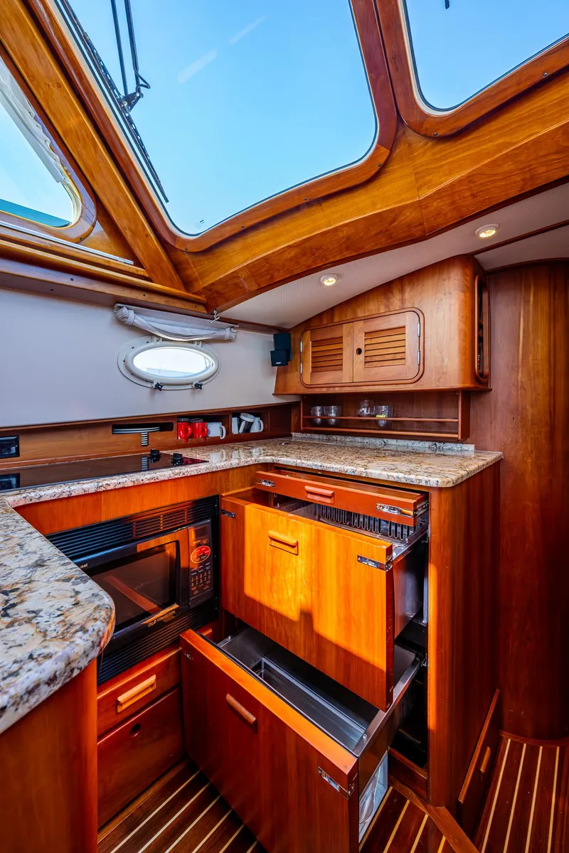 Slide: The Image of 2006 Hinckley Talaria 44 MY yacht kitchen with wood cabinetry and granite countertops. - 20
