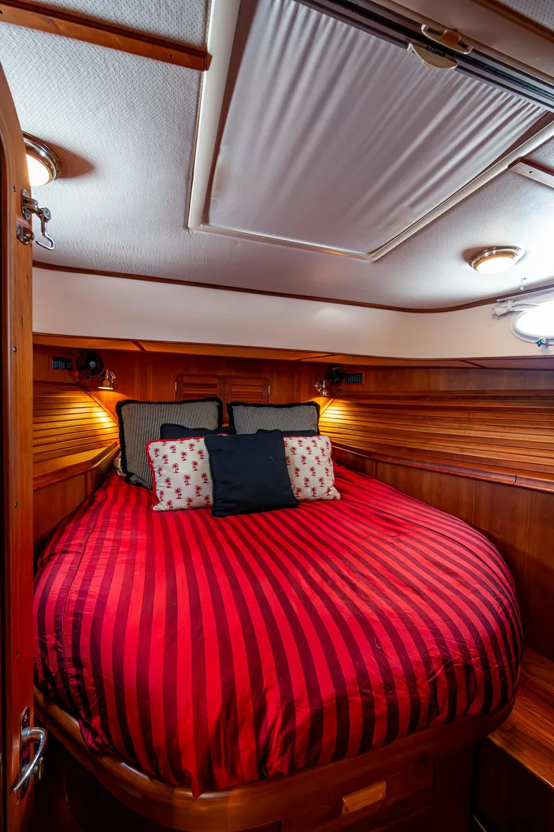 Slide: The Image of Luxurious cabin interior of 2006 Hinckley Talaria 44 MY with red-striped bedding. - 25