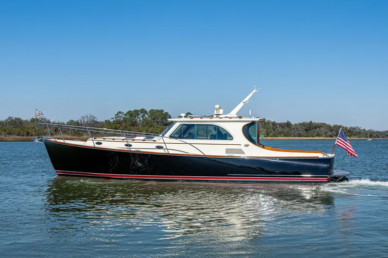 Slide: The Image of 2006 Hinckley Talaria 44 MY yacht cruising on calm waters under clear blue skies. - 32