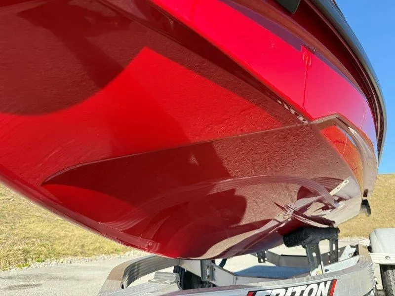 Slide: The Image of 2024 Sea-Doo RXT-X 325 in vibrant red on a trailer, side view. - 31