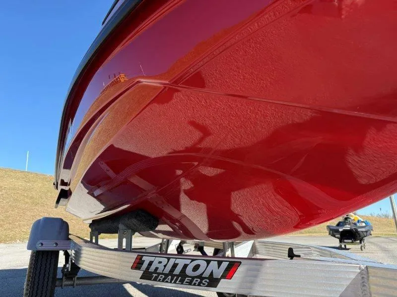 Slide: The Image of 2024 Sea-Doo RXT-X 325 on Triton trailer, red hull, sunny day. - 32