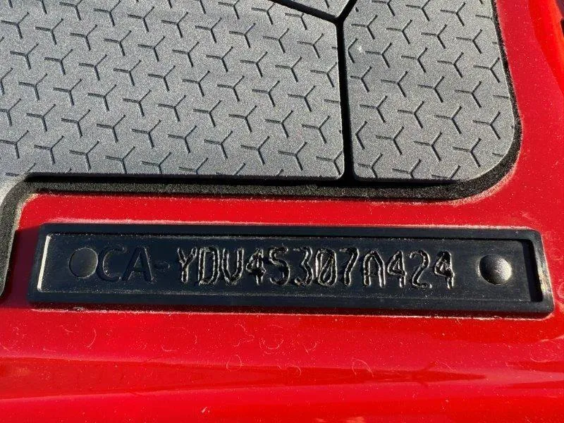 Slide: The Image of Close-up of 2024 Sea-Doo RXT-X 325 serial number on red surface. - 33