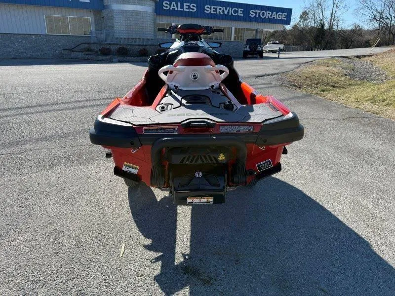 Slide: The Image of 2024 Sea-Doo RXT-X 325 jet ski, rear view, parked near sales and service building. - 8