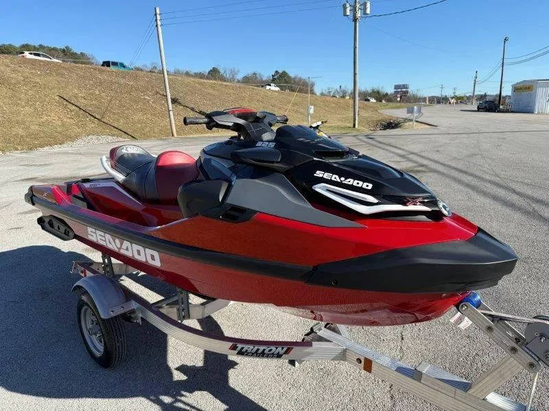 Slide: The Image of 2024 Sea-Doo RXT-X 325 jet ski on trailer, parked outdoors, sunny day. - 9