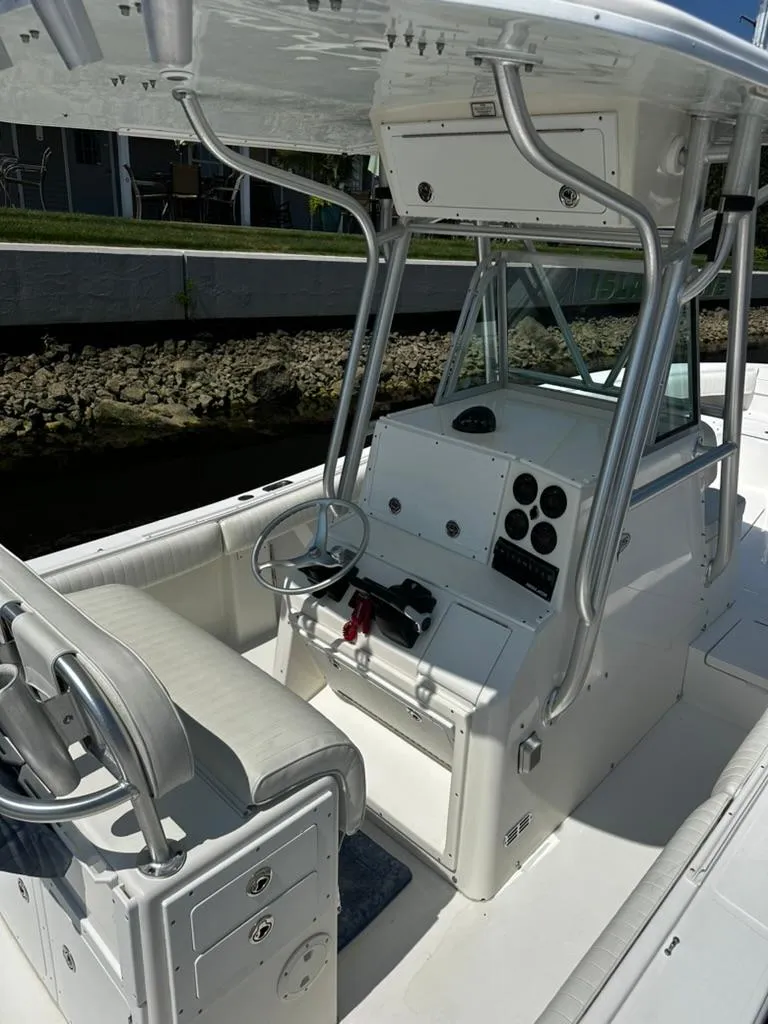 Slide: The Image of 2005 Regulator 26 FS boat interior with steering console and seating. - 4