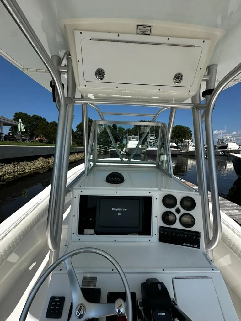 Slide: The Image of 2005 Regulator 26 FS boat cockpit with steering wheel and navigation system. - 6
