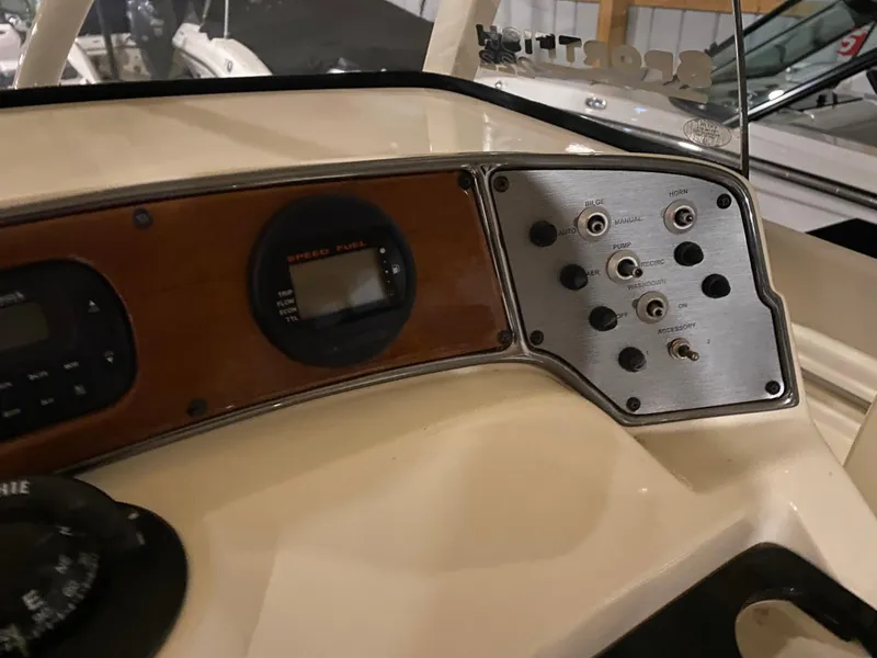 Slide: The Image of Dashboard of a 2011 Scout 222 Sportfish boat with control panel and gauges. - 28