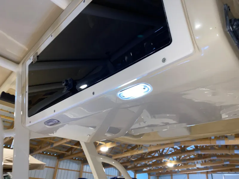 Slide: The Image of 2011 Scout 222 Sportfish boat interior with overhead lighting and storage compartment. - 33
