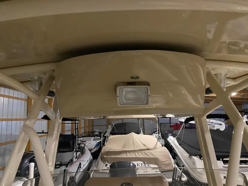 Slide: The Image of 2011 Scout 222 Sportfish boat interior with overhead light in storage facility. - 40